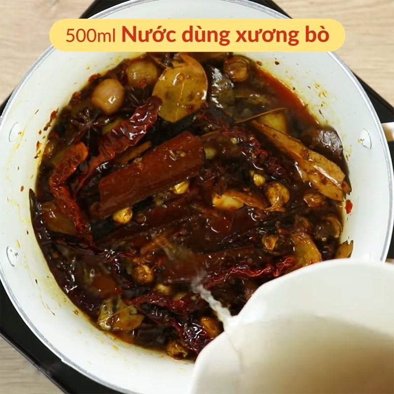 Thêm nước dùng vào chảo nguyên liệu khô